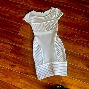 BEBE Bodycon dress.  Dress is a blush/nude color Size XS